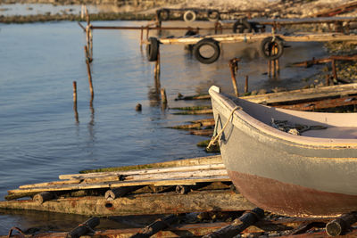 Abandoned boat moored at beach