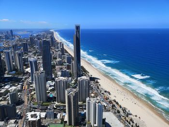 High angle view of buildings by sea against sky