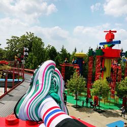 Low angle view of multi colored swing ride against sky