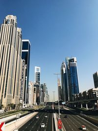 View of city street and buildings against sky