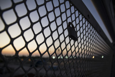 Close-up of chainlink fence against sky