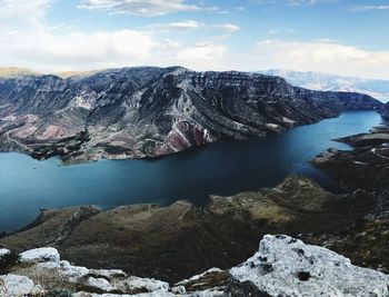 Rock formations in lake against sky