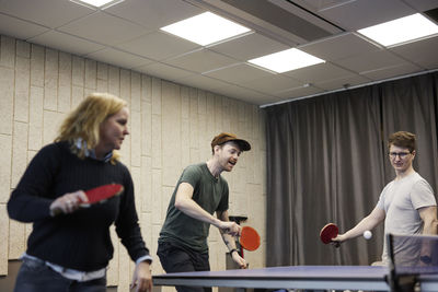 People playing table tennis in office