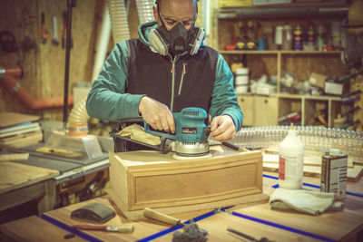 Rear view of man working in workshop