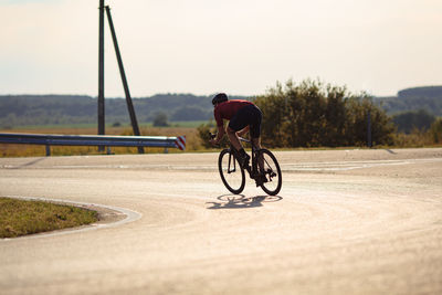 Man riding bicycle on road