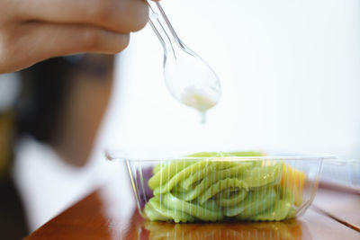 Close-up of person preparing food on table