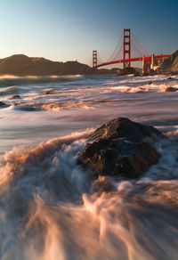 View of suspension bridge over sea