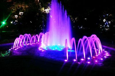 Illuminated fountain at night