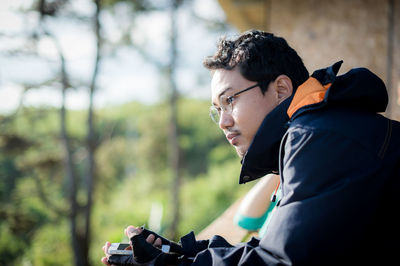 Close-up of man looking away outdoors