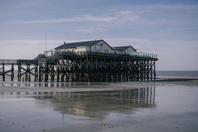 Pier over sea against sky