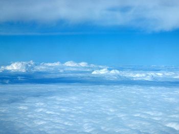 Aerial view of clouds over sea against sky