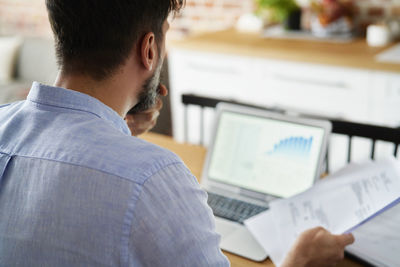 Rear view of businessman working at office