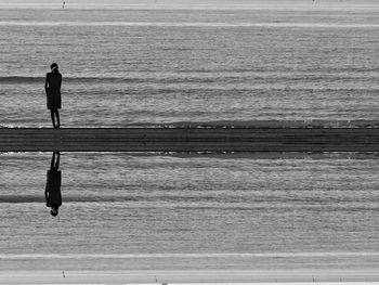 Man and woman walking on beach