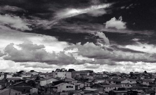 Buildings against cloudy sky