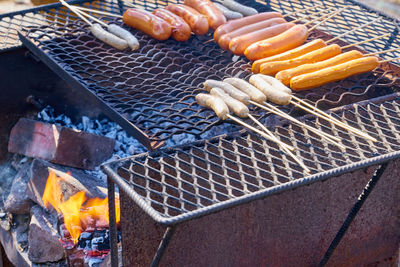 Grilled sausages outdoor on vintage rusted grill.