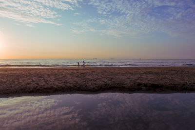 Scenic view of beach against sky during sunset