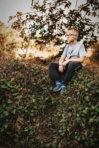 Full length of young man sitting on field