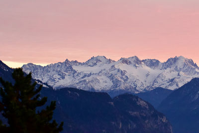 Scenic view of snowcapped mountains against sky during sunset