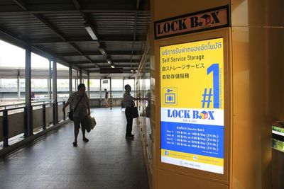 Rear view of people walking on railroad station platform