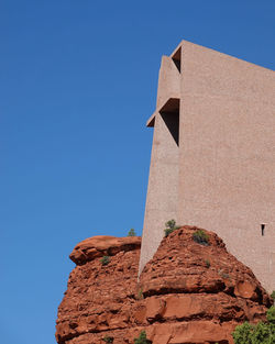 Low angle view of building against clear blue sky