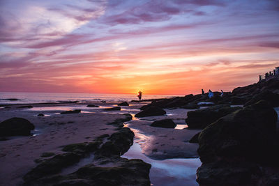 Scenic view of beach against sky during sunset