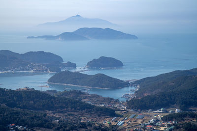 Scenic view of sea and mountains against sky