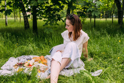 Young woman sitting on field