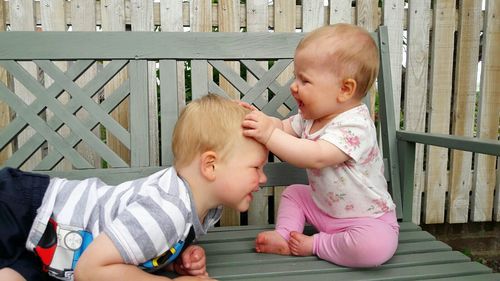 Close-up of boy and baby playing outdoors