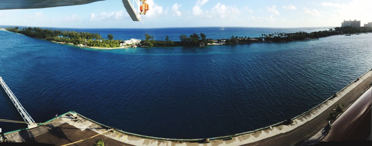 sea, water, horizon over water, sky, nautical vessel, transportation, mode of transport, high angle view, built structure, architecture, scenics, boat, nature, blue, travel, day, beauty in nature, tranquility, building exterior, cloud - sky