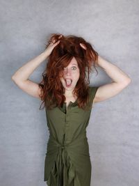 Portrait of beautiful young woman against white background