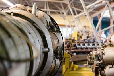 Close-up of aircraft turbine engine and other machinery machinery in a warehouse