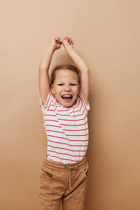 Smiling girl against beige background