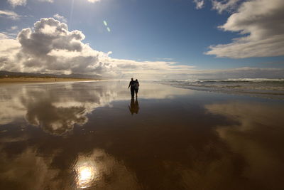 Scenic view of sea against cloudy sky