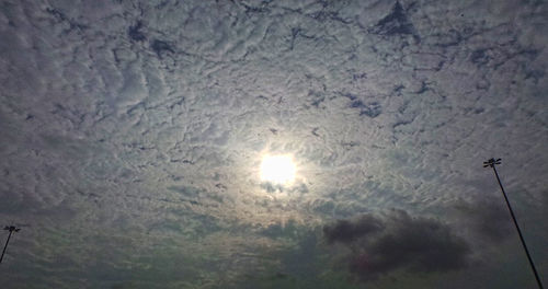 Low angle view of sun shining in sky