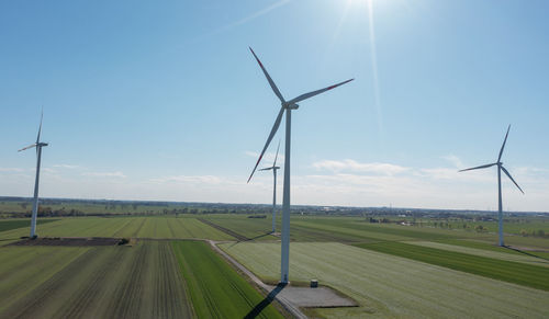 Windmill on field against sky