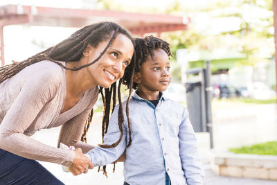 Mother and son standing on playground