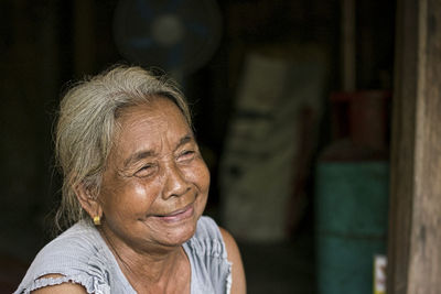 A close-up of a single indigenous woman smiling