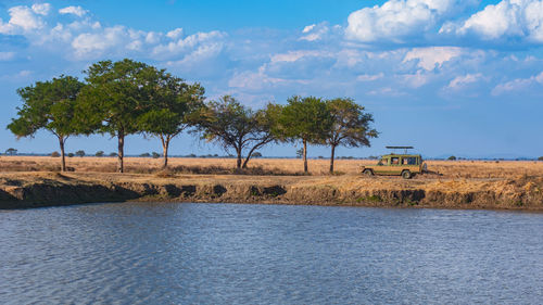 Scenic view of a safari vehicle in mikumi national park  against sky