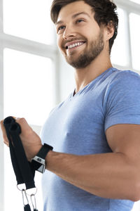 Portrait of young man exercising in gym