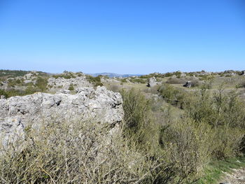 Scenic view of land against clear blue sky