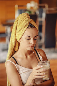 Young beautiful woman with a towel on her head.