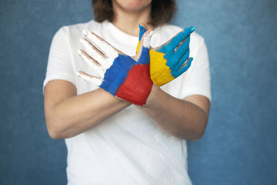 Midsection of woman with paint on hands