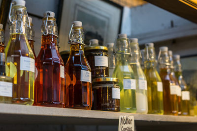 Close-up of drinks in glass bottles on shelf