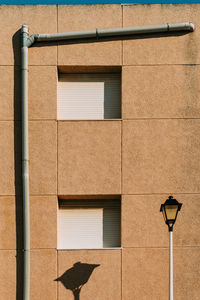 Low angle view of street light against building