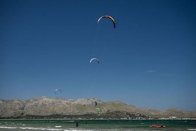 People paragliding in sea