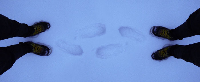 Low section of man standing in the dark