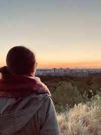 Rear view of woman looking at sunset