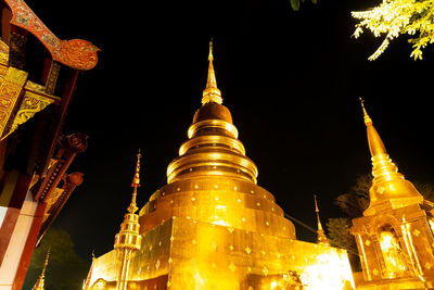 Low angle view of illuminated buildings at night