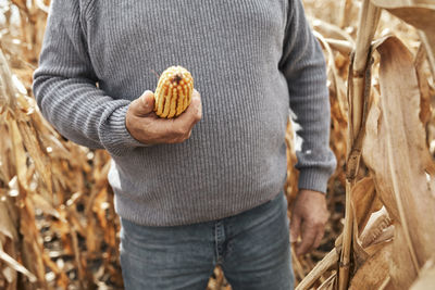 Midsection of man holding ice cream