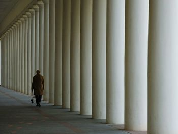 Rear view of woman walking in corridor